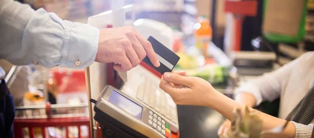 Man Paying with Credit Card in Supermarket